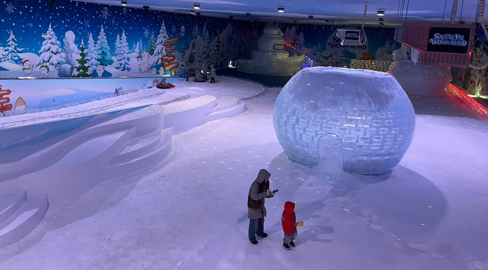 Crianças a brincar na neve no Snowyn Wonderland em Bangkok Crianças a brincar na neve no Snowyn Wonderland em Bangkok